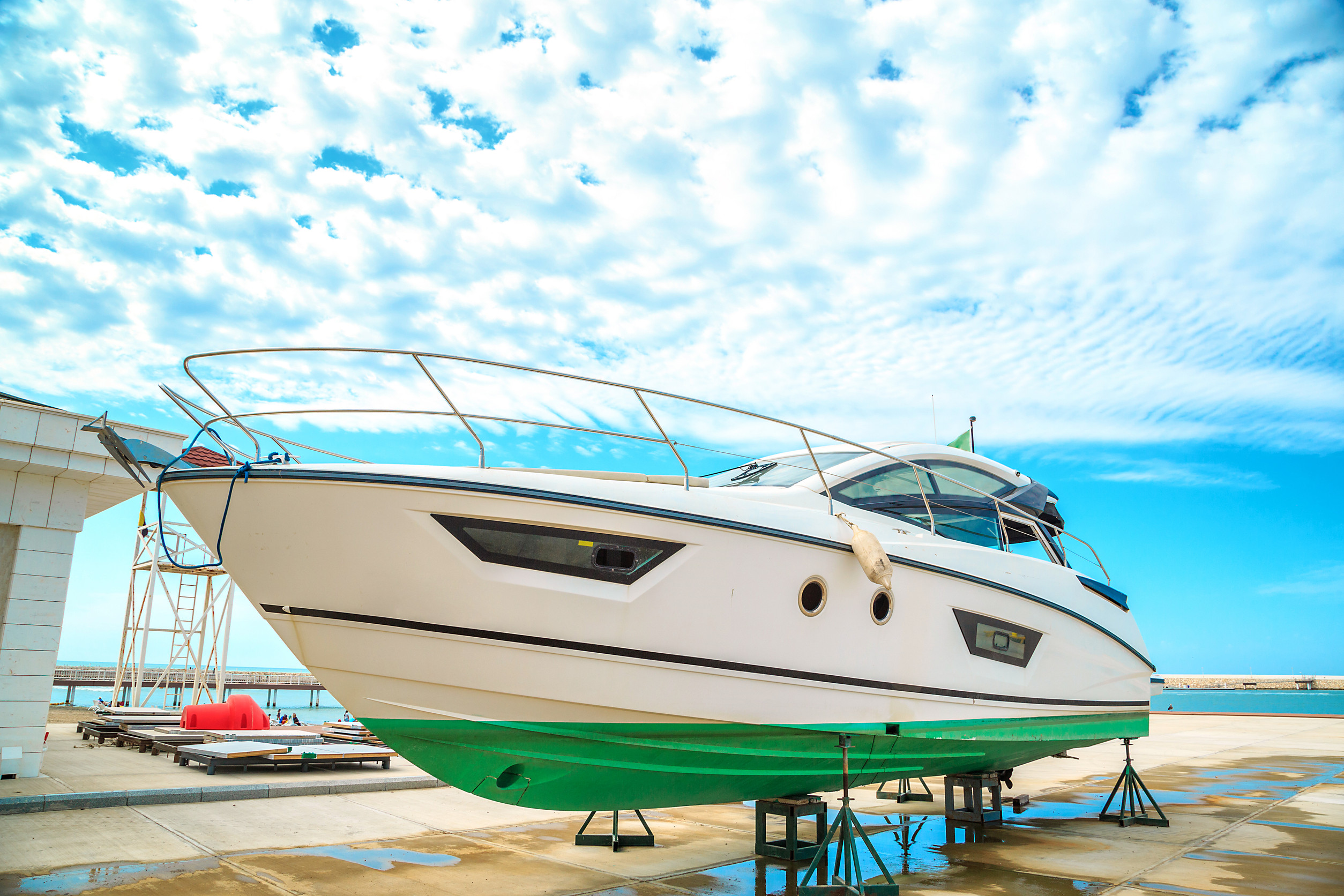 a snow white yacht stands on a pier on coasters on a Sunny day a
